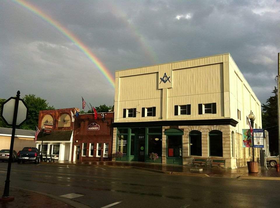 Image of Shepherd Community Library with rainbow over top