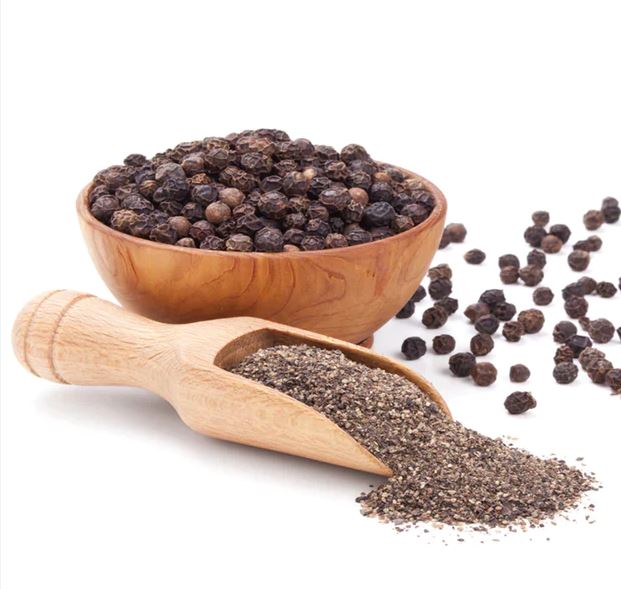 Image of peppercorns in bowl and ground pepper in a scoop
