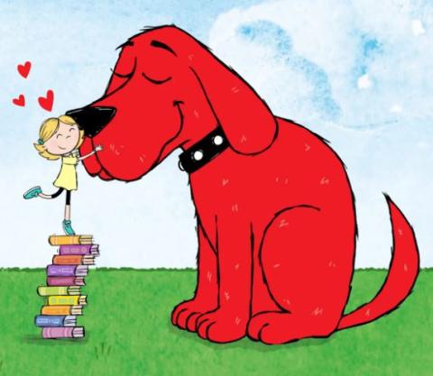 Image opf Clifford the big red dog with Emily Elizabeth standing on books