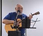 Image of Don Masselli singing and playing guitar.
